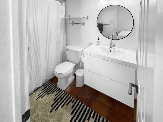 bathroom with tile patterned flooring, vanity, and toilet