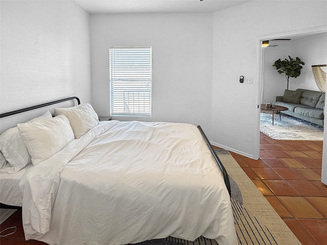 bedroom with dark tile patterned floors