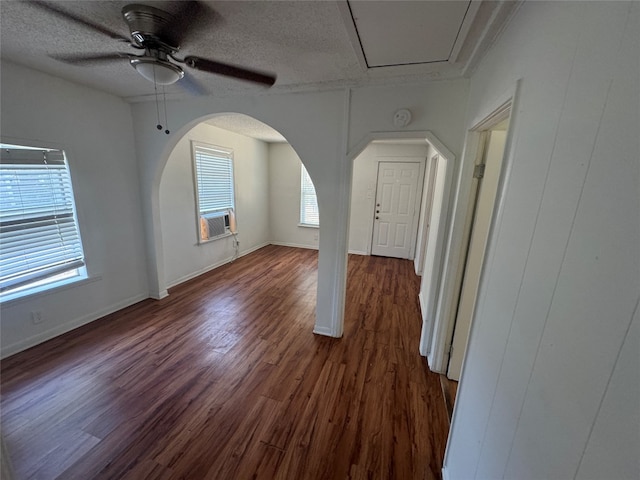 unfurnished room with ceiling fan, dark hardwood / wood-style flooring, and a textured ceiling