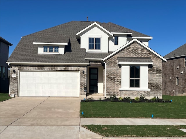 view of front facade featuring a garage and a front lawn