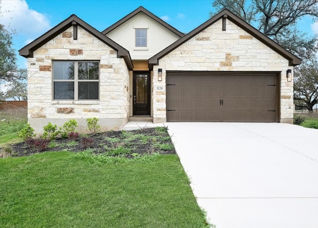 view of front of home with a garage and a front lawn