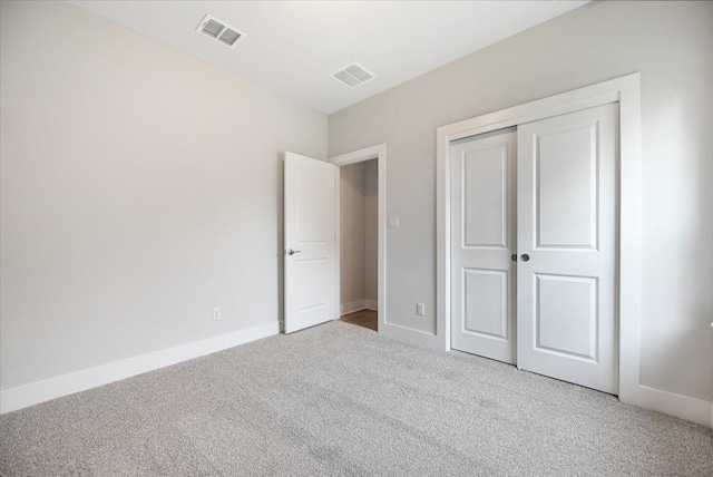 unfurnished bedroom with a closet and carpet floors