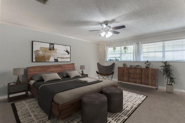 bedroom with a textured ceiling, ceiling fan, carpet floors, and crown molding