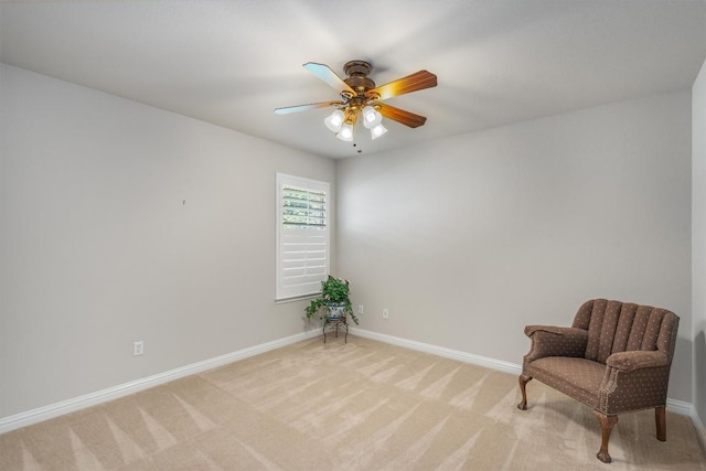 sitting room with ceiling fan and light colored carpet