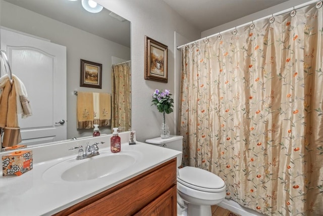 bathroom with vanity, toilet, and walk in shower