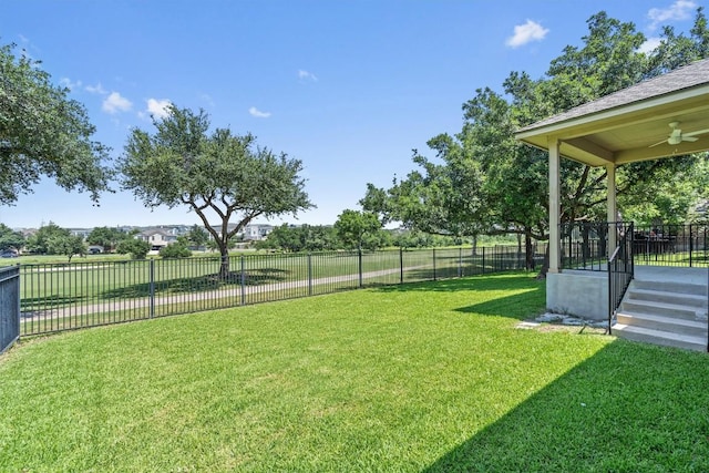 view of yard featuring ceiling fan