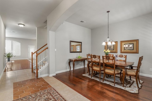 dining area featuring tile patterned floors and a notable chandelier