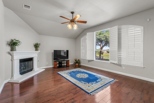 living room featuring ceiling fan, dark hardwood / wood-style floors, and vaulted ceiling