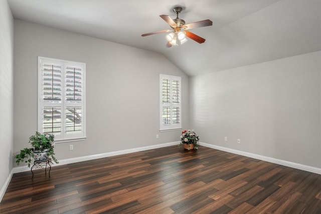 unfurnished room featuring ceiling fan, dark hardwood / wood-style flooring, and vaulted ceiling