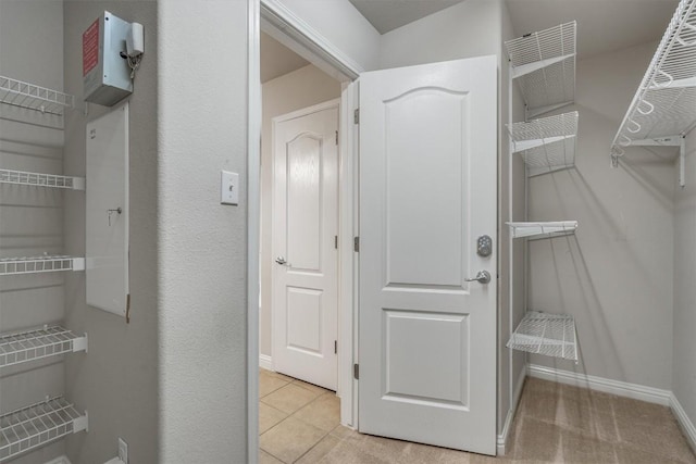 spacious closet featuring light tile patterned floors