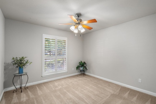 spare room featuring ceiling fan and light carpet