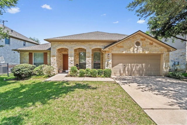 view of front of property with a front yard and a garage