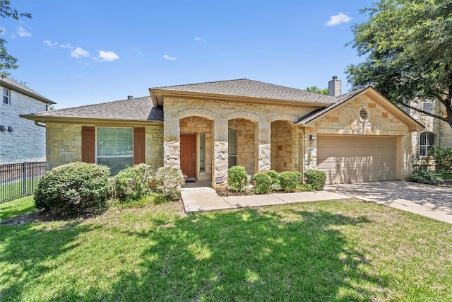 1102 Winding Creek Pl, Round Rock, TX 78665 - view of front of house featuring a front lawn, stone siding, a shingled roof, an attached garage, and fence