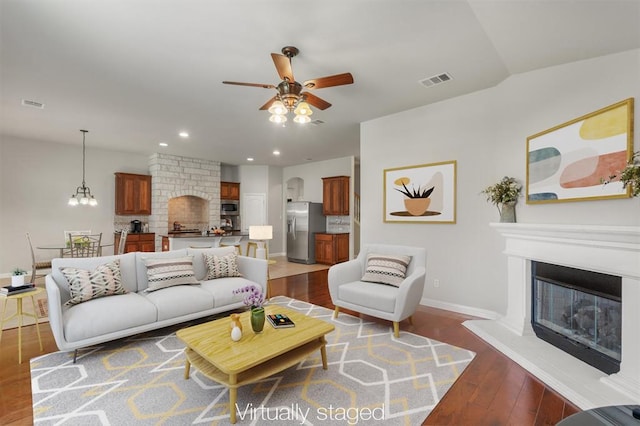 1102 Winding Creek Pl, Round Rock, TX 78665 - living area with hardwood / wood-style floors, a glass covered fireplace, ceiling fan, baseboards, and visible vents