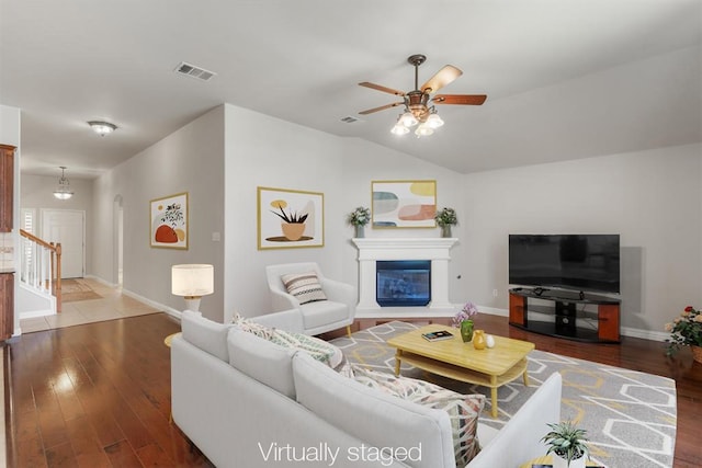 1102 Winding Creek Pl, Round Rock, TX 78665 - living area with baseboards, a glass covered fireplace, wood finished floors, and visible vents