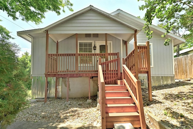 view of front of home with fence and stairway