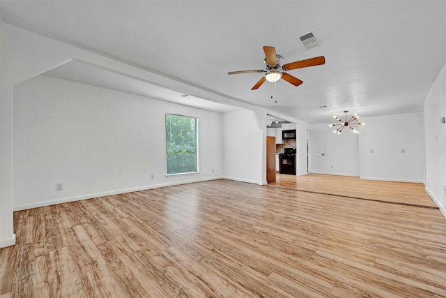 unfurnished living room featuring baseboards, visible vents, light wood finished floors, and ceiling fan with notable chandelier