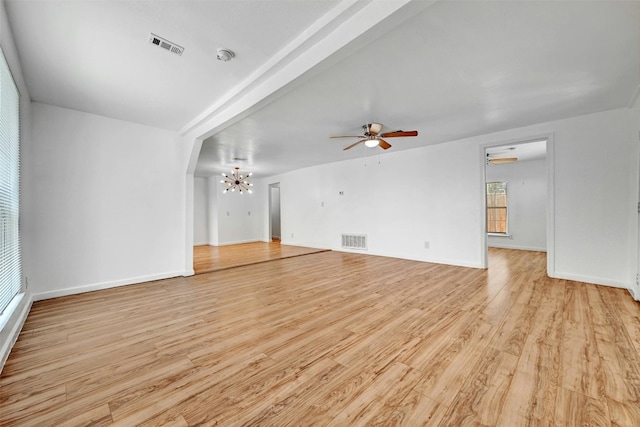 unfurnished living room featuring beam ceiling, ceiling fan with notable chandelier, and light hardwood / wood-style floors