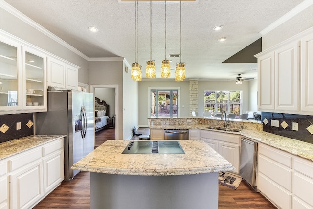 kitchen with white cabinets, stainless steel appliances, and a kitchen island