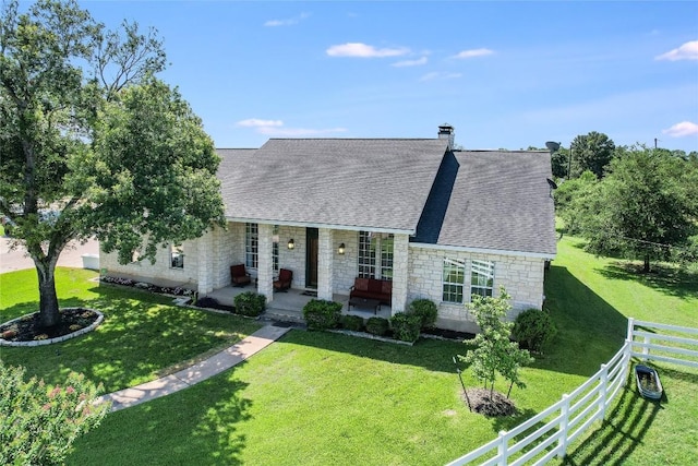 single story home featuring a front lawn