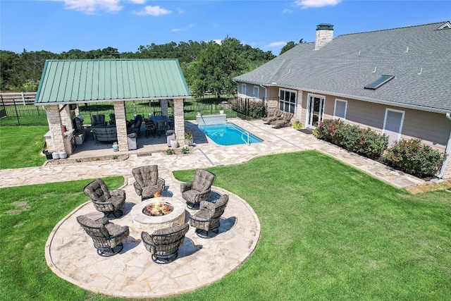 view of pool featuring a lawn, a fire pit, a patio area, and a gazebo