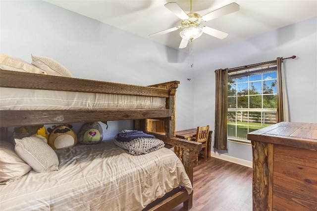 bedroom with ceiling fan and dark hardwood / wood-style floors