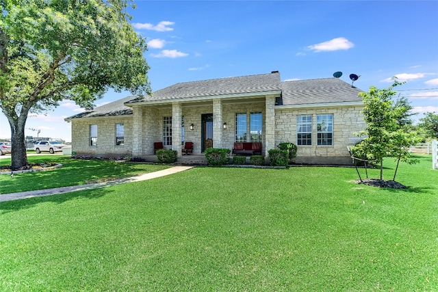 view of front of home with covered porch and a front lawn