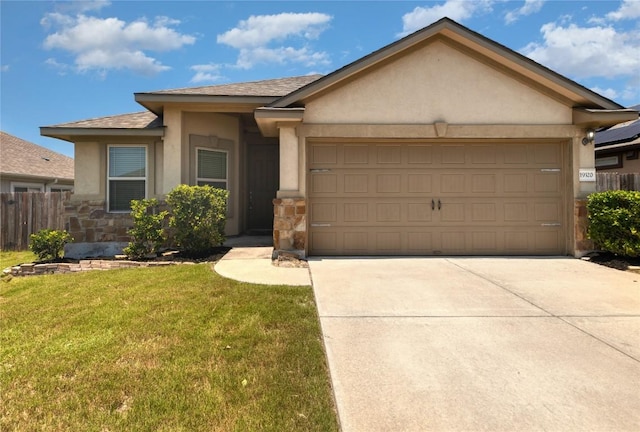 single story home featuring a garage and a front yard