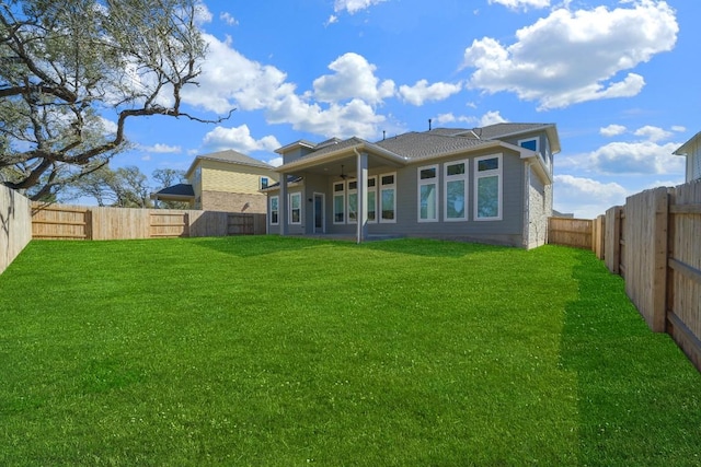 rear view of property with a yard