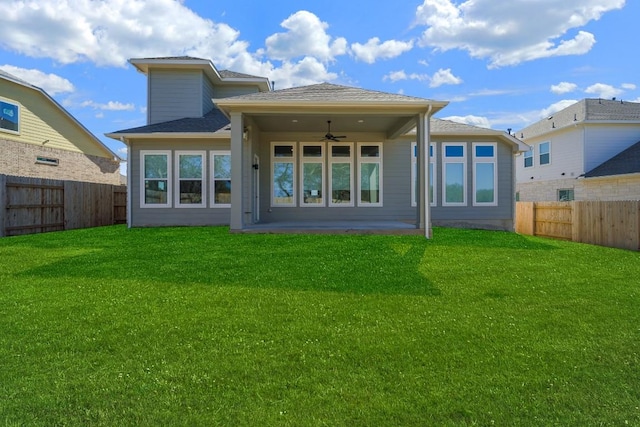 back of property featuring ceiling fan, a patio, and a yard