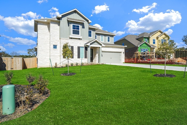 view of front of home with a garage and a front lawn