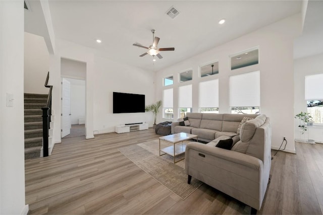 living room featuring light wood-type flooring and ceiling fan