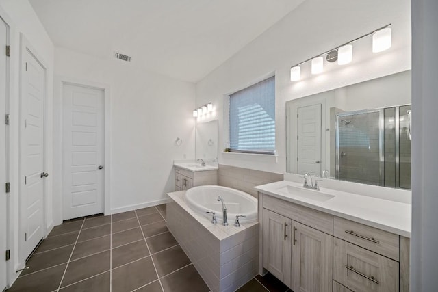 bathroom featuring vanity, independent shower and bath, and tile patterned floors