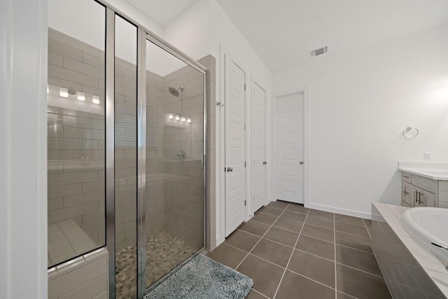 bathroom featuring vanity, tile patterned floors, and separate shower and tub