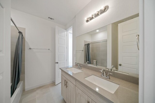 bathroom with vanity, shower / tub combo, and tile patterned flooring