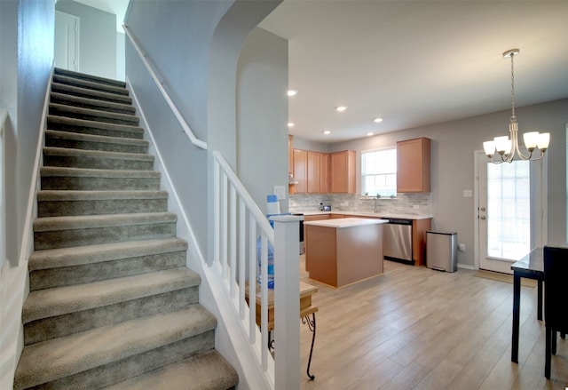 stairway with a chandelier and hardwood / wood-style floors