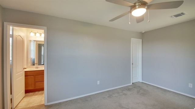 carpeted spare room with ceiling fan