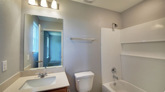 full bathroom with tiled shower / bath, toilet, and vanity