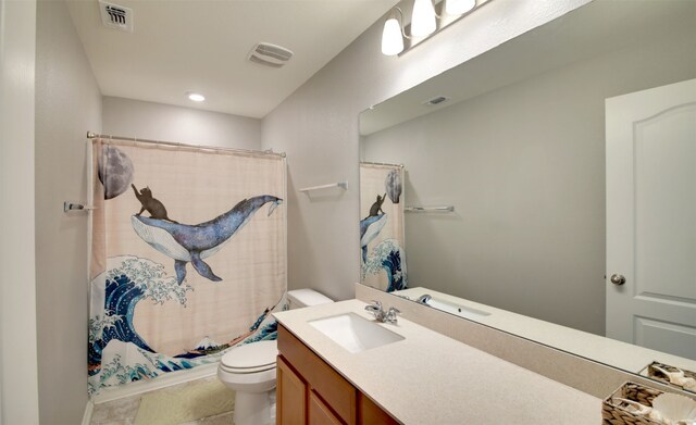 bathroom with tile floors, oversized vanity, and toilet