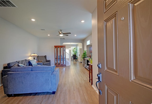 living room with ceiling fan and light hardwood / wood-style floors