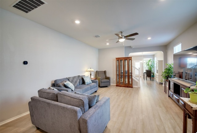 living room with ceiling fan, a healthy amount of sunlight, and wood-type flooring