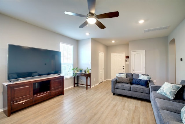 living room with light hardwood / wood-style flooring and ceiling fan