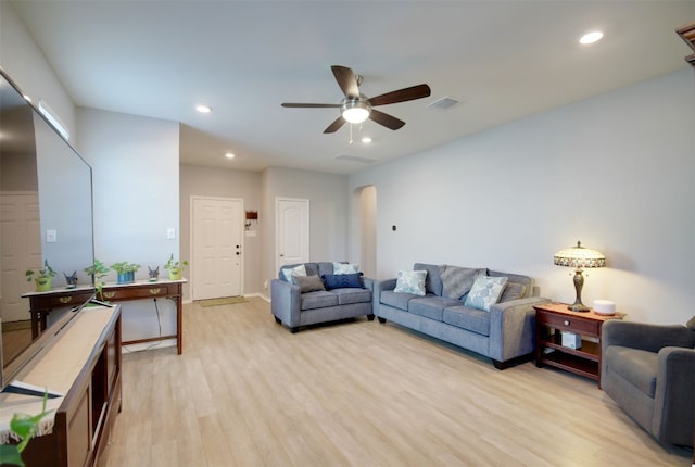 living room with ceiling fan and light hardwood / wood-style flooring