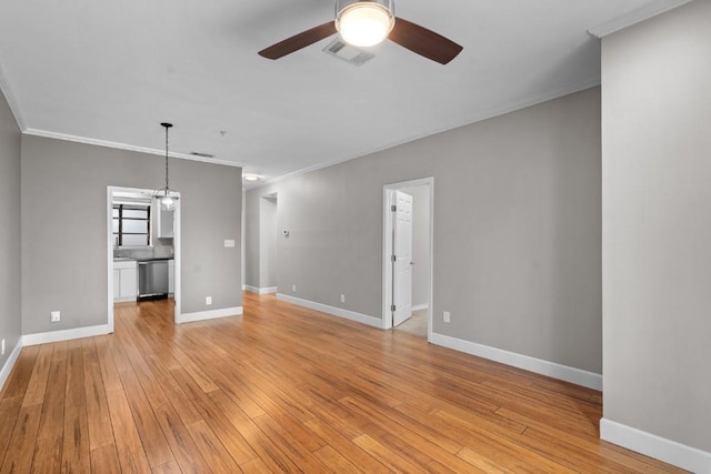 unfurnished living room featuring ceiling fan with notable chandelier, ornamental molding, and light hardwood / wood-style flooring