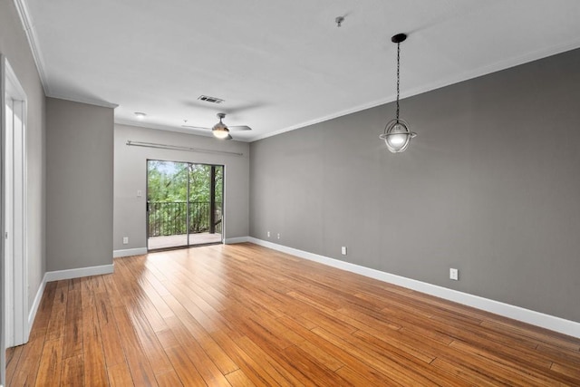 spare room with light hardwood / wood-style flooring, ceiling fan, and ornamental molding