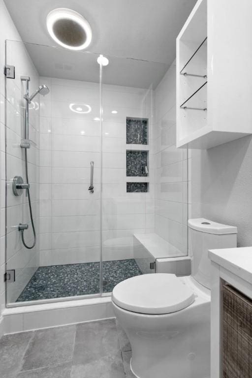 bathroom featuring walk in shower, vanity, and toilet