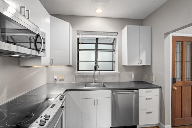 kitchen featuring white cabinetry, sink, and appliances with stainless steel finishes