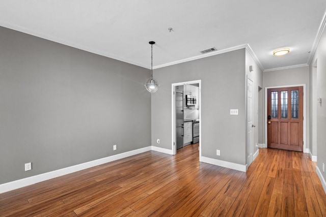 interior space featuring ornamental molding and hardwood / wood-style flooring