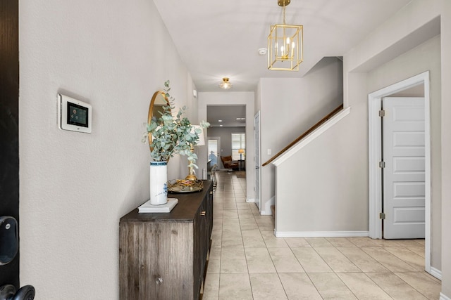 foyer with a notable chandelier and light tile patterned floors