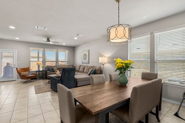 dining space featuring ceiling fan and light tile patterned floors